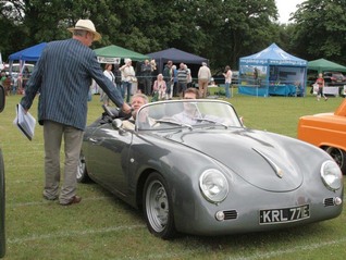 Andrew Snowdon speaks to the owner of a 356 Porsche Replica from the motorcade of classic cars